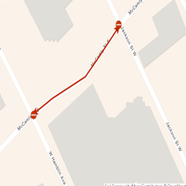 A city street map showing the closure of McCamly Street as a red line with two road blocks.