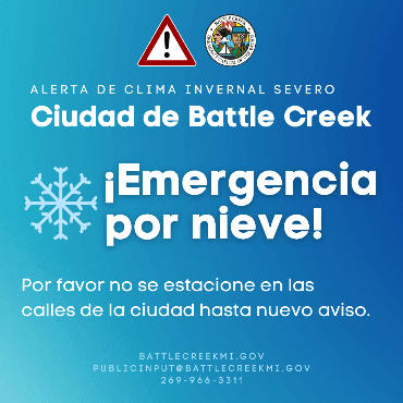 Blue with snowflake and text City of Battle Creek snow emergency in Spanish