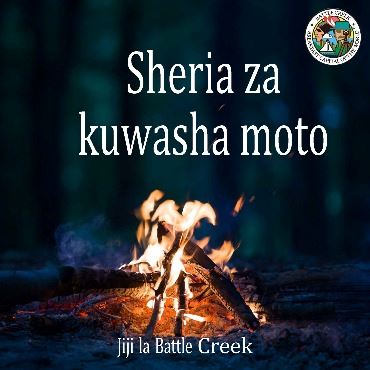 Small bonfire at night with text in Swahili about burning in the city.