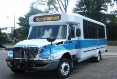 A white and blue public bus