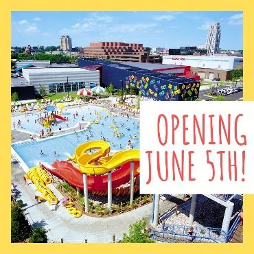 Overhead view of water park full of visitors in pool and two slides. Text says 