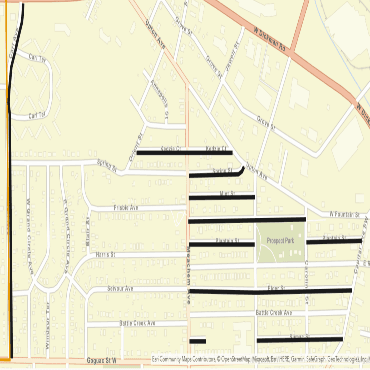 A city street map showing paving projects along several roadways as black lines.