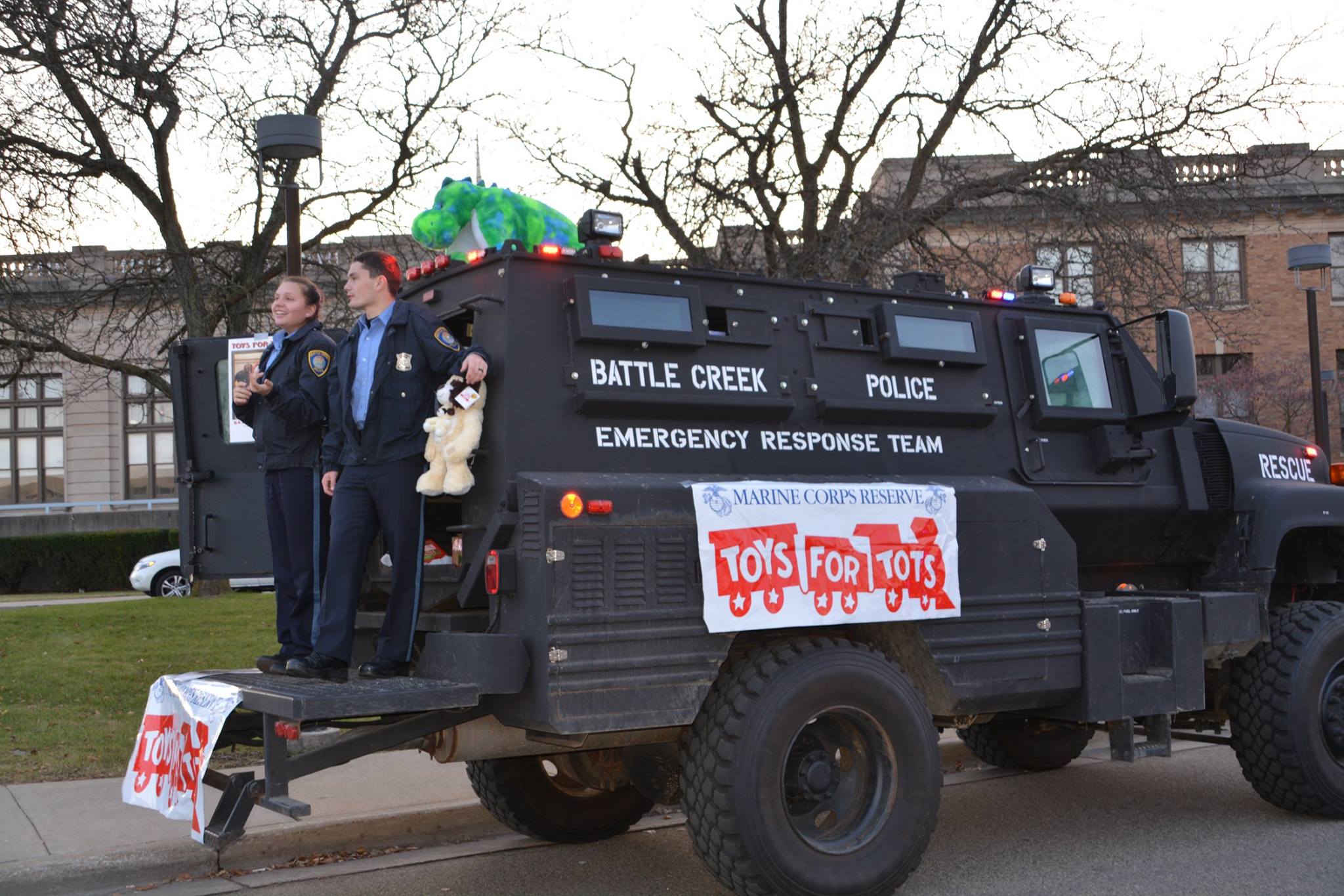 Black Battle Creek Police Emergency Response Team truck parked and displaying Toys for Tots banners.