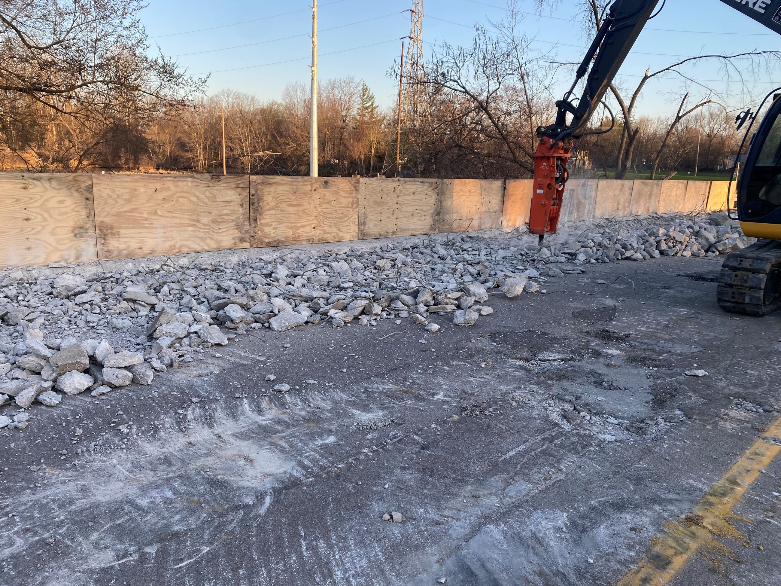 Jack hammer on bridge, with chunks of concrete around.